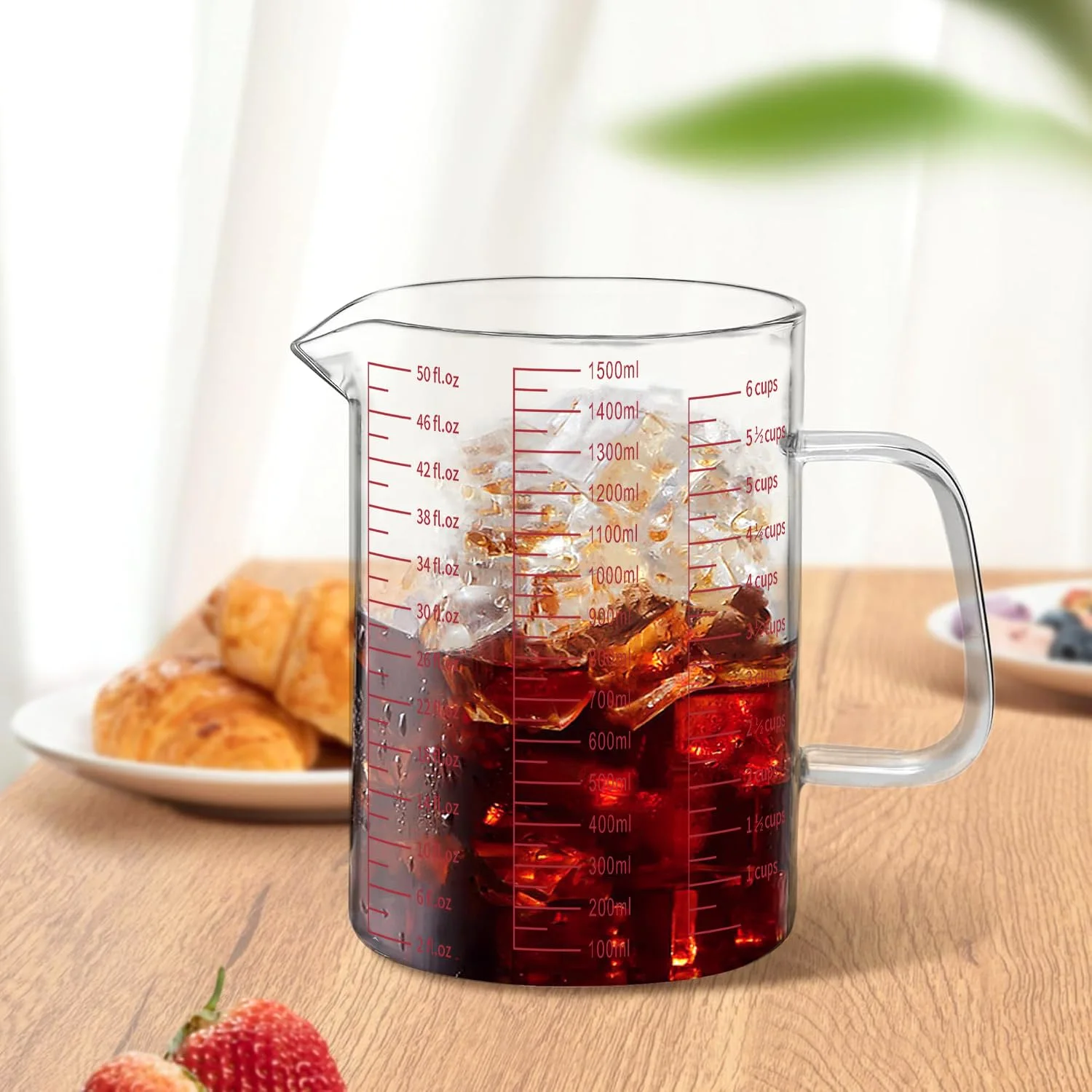Iced tea in the 6 cup Luvan glass measuring cup, with milliliter and ounce lines up the side.
