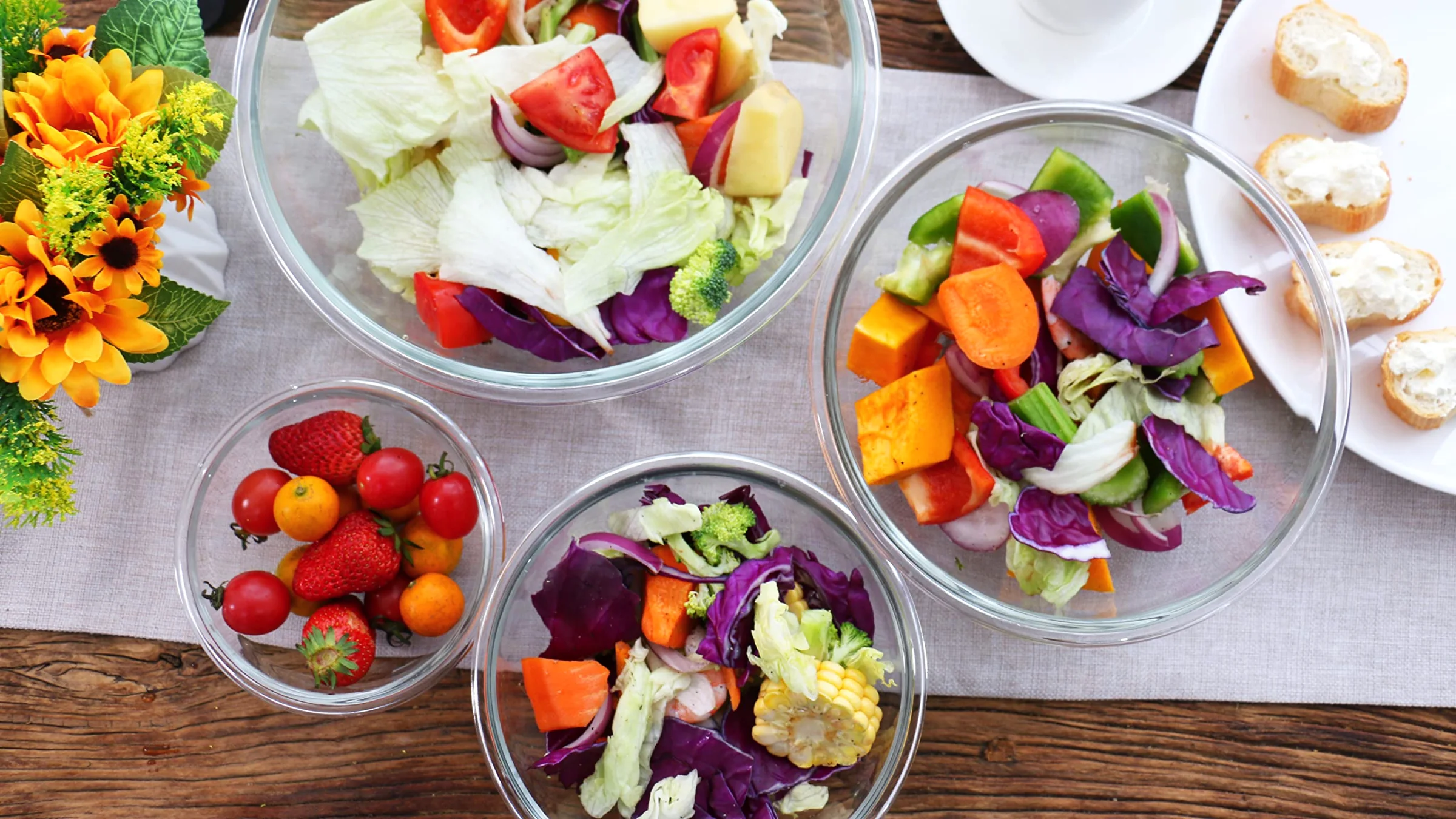 Salads and fruit in Luvan glass bowls on a kitchen counter